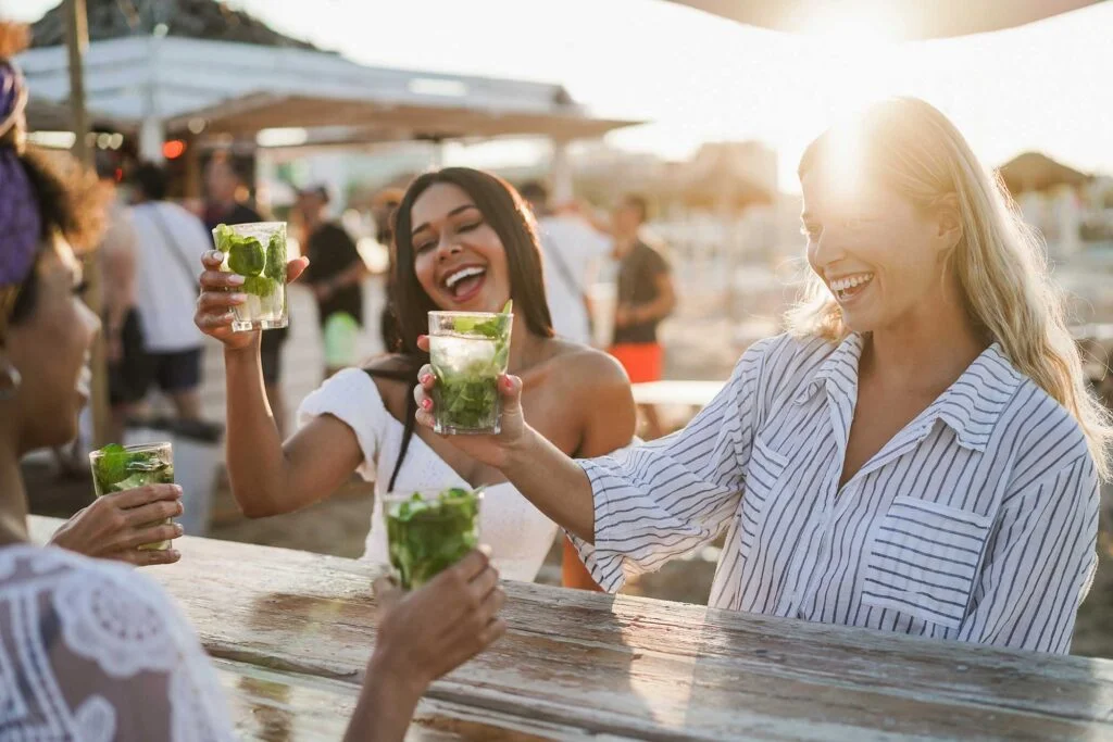 happy-girls-having-fun-cheering-with-cocktails-at-5V9ZUL7.jpg